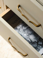 Open drawer with antique brass bamboo pull — lifestyle shot