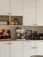 Polished chrome pebble knobs installed on cream kitchen cabinets with coffee station styling
