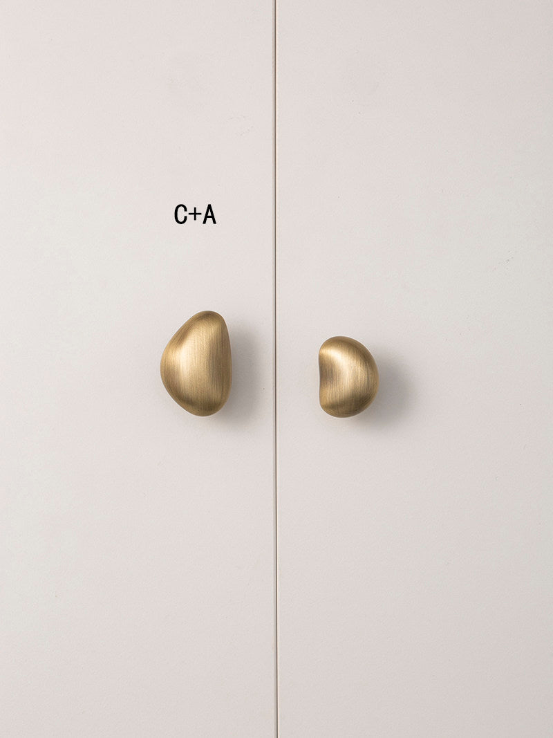 Mixed size C and A brushed brass pebble knobs styling