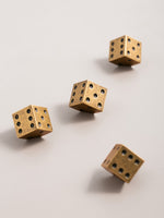 Antique brass dice cabinet knobs — 4 pieces scattered flat lay