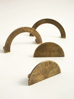 Antique brass sunray arch and half-moon pulls — mixed styles flat lay