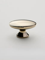 Nickel silver oval cabinet knob on white background — pedestal base side view