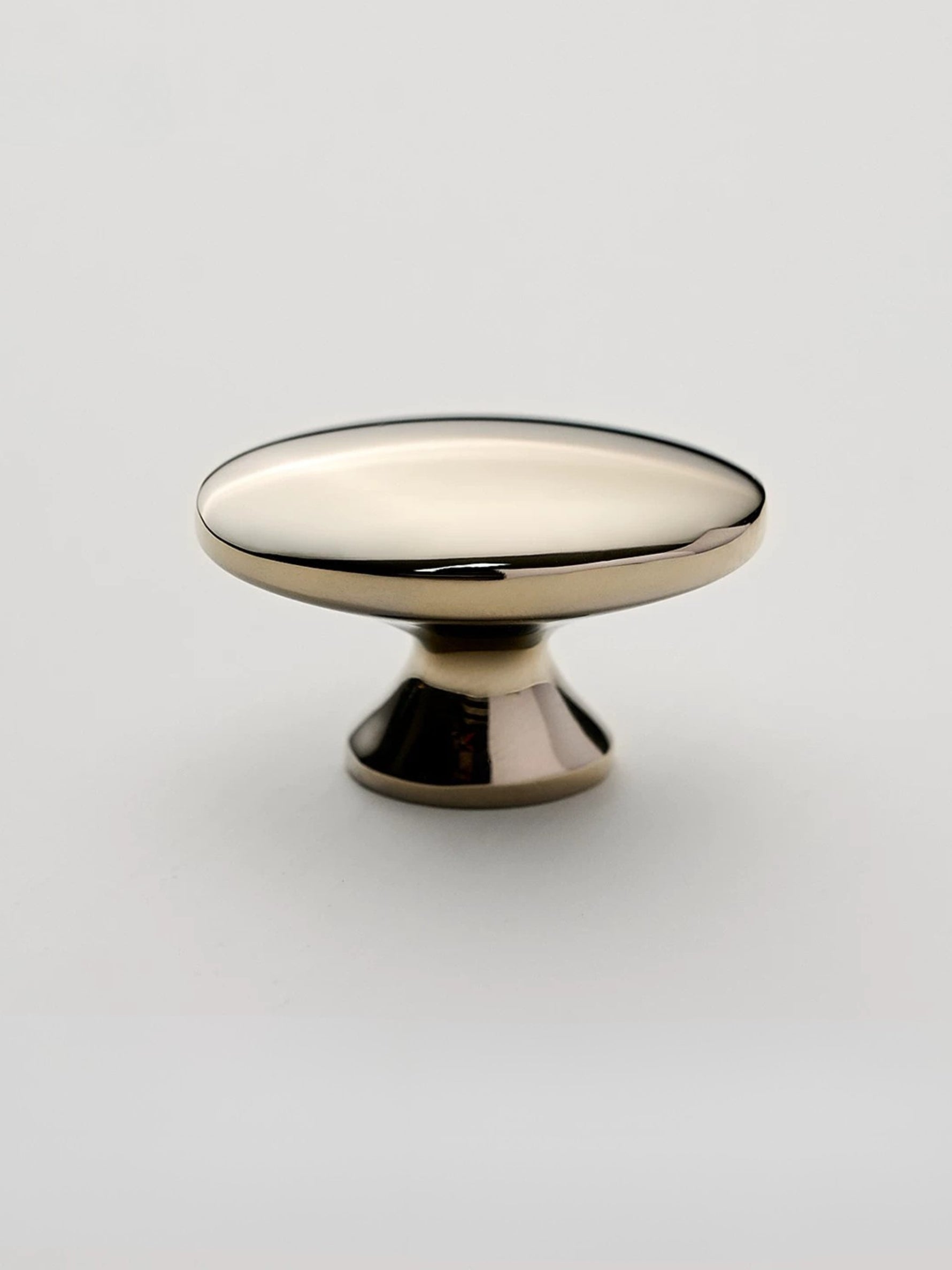 Nickel silver oval cabinet knob on white background — pedestal base side view