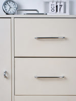 Polished chrome bar pulls on cream dresser with clock and calendar styling