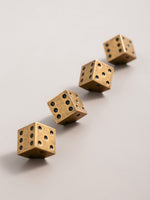Antique brass dice cabinet knobs in diagonal row