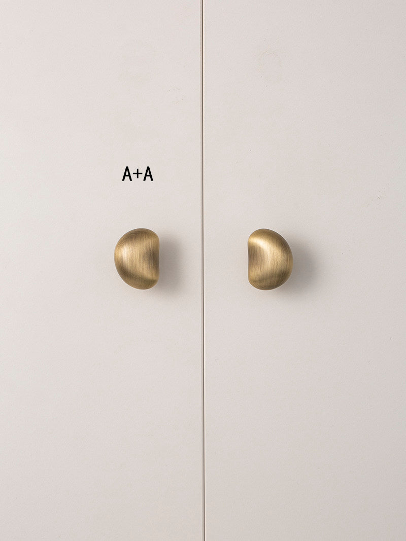 Size A brushed brass pebble knobs paired on wardrobe