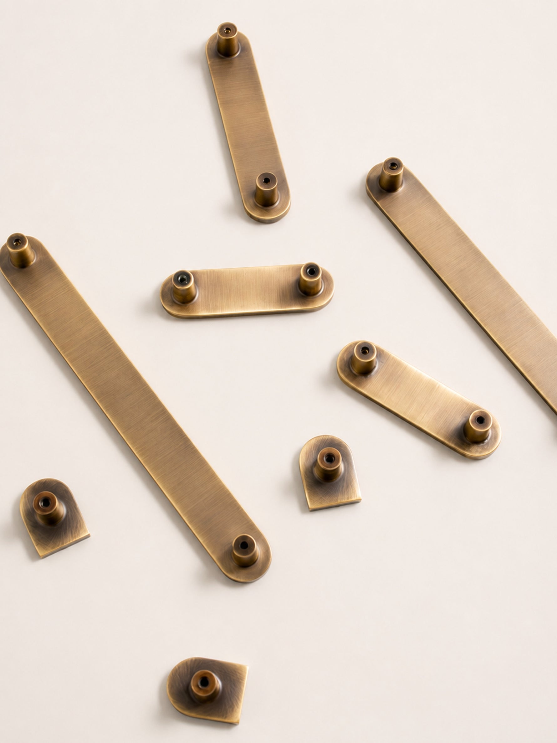 Back view of solid brass Art Deco arch cabinet pulls showing screw posts and mounting detail
