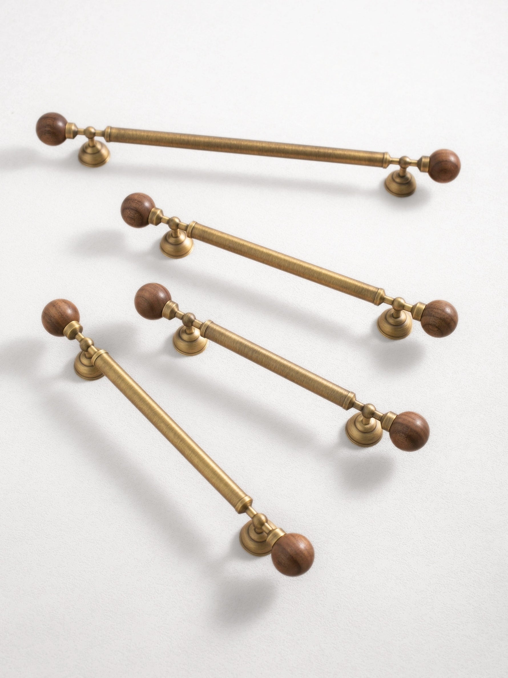 Multiple antique brass walnut ball pulls diagonal arrangement