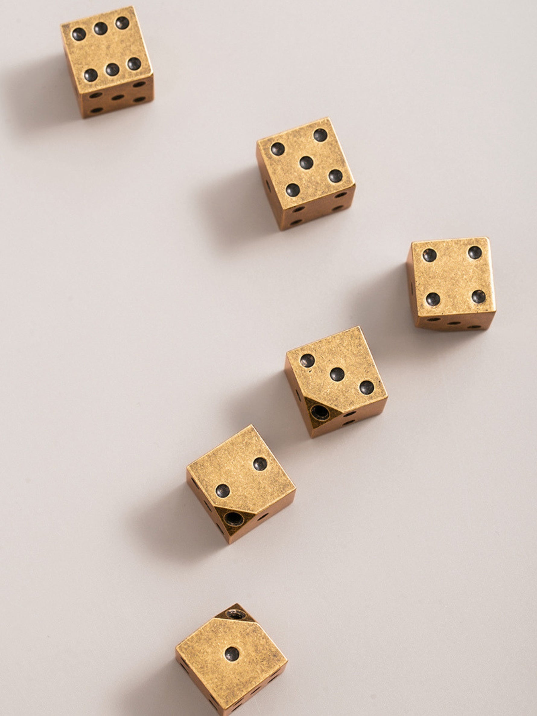 Antique brass dice knobs — top view scattered arrangement