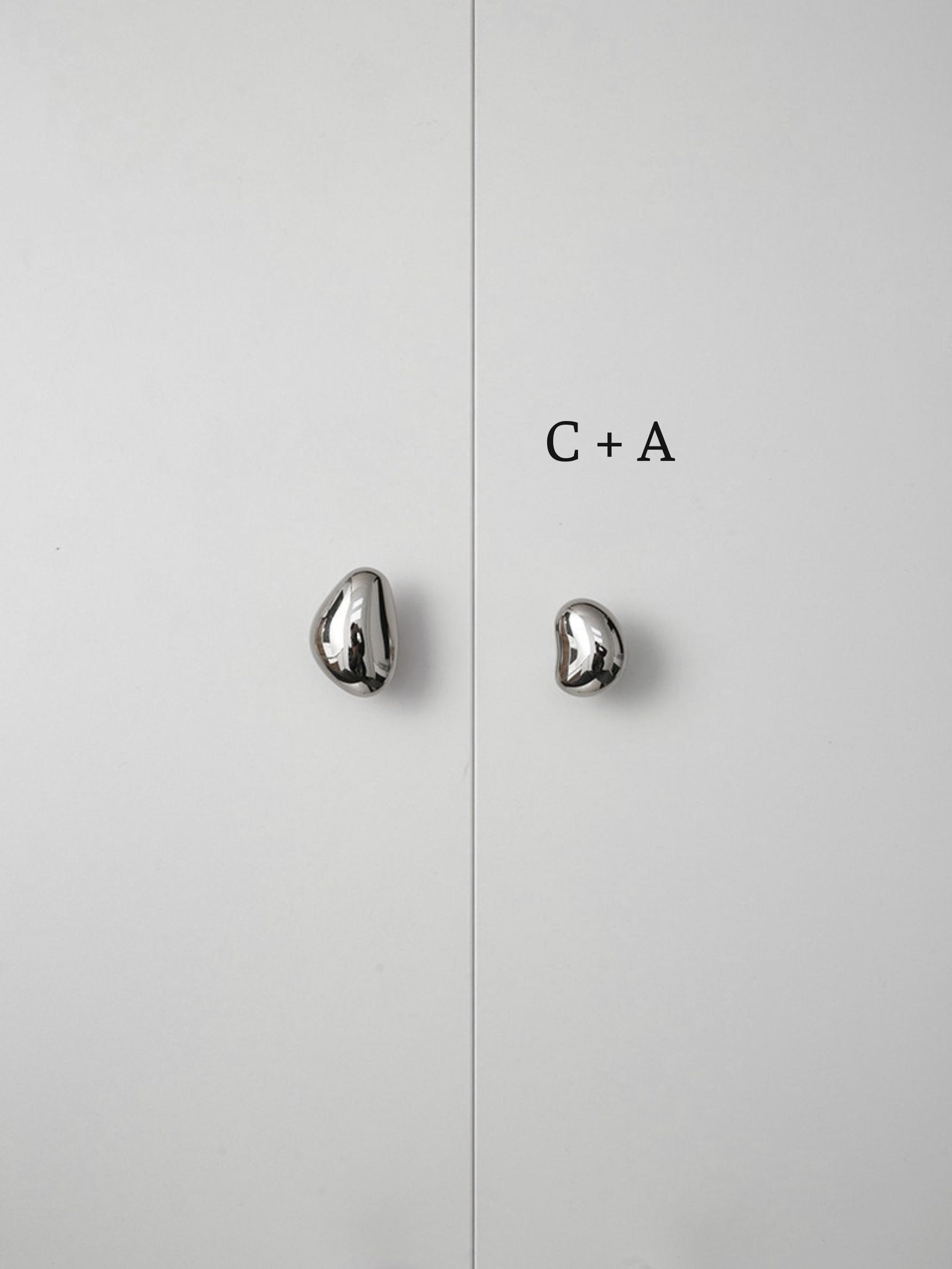 Polished chrome pebble knobs on white cabinet doors labeled size C plus A comparison