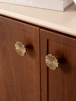 Small antique brass ginkgo knobs on walnut kitchen cabinet