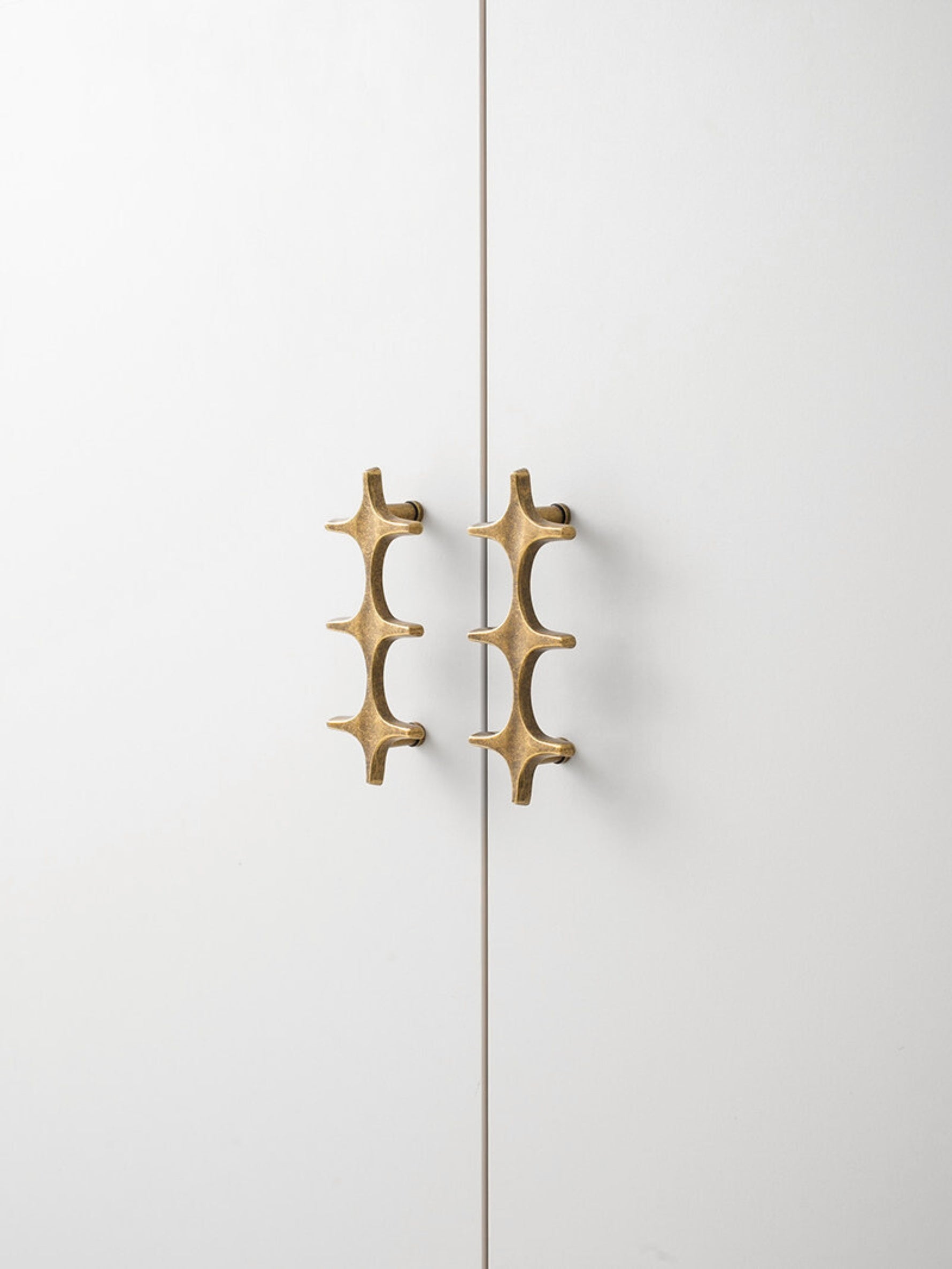 Antique Brass Star Pull Side Profile on Cabinet Door OlumeHardware