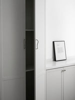 Chrome wave pulls on light grey wardrobe cabinetry