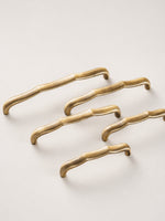 Antique brass bamboo pulls — diagonal arrangement flat lay