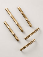 Antique brass straight bamboo pulls — vertical flat lay