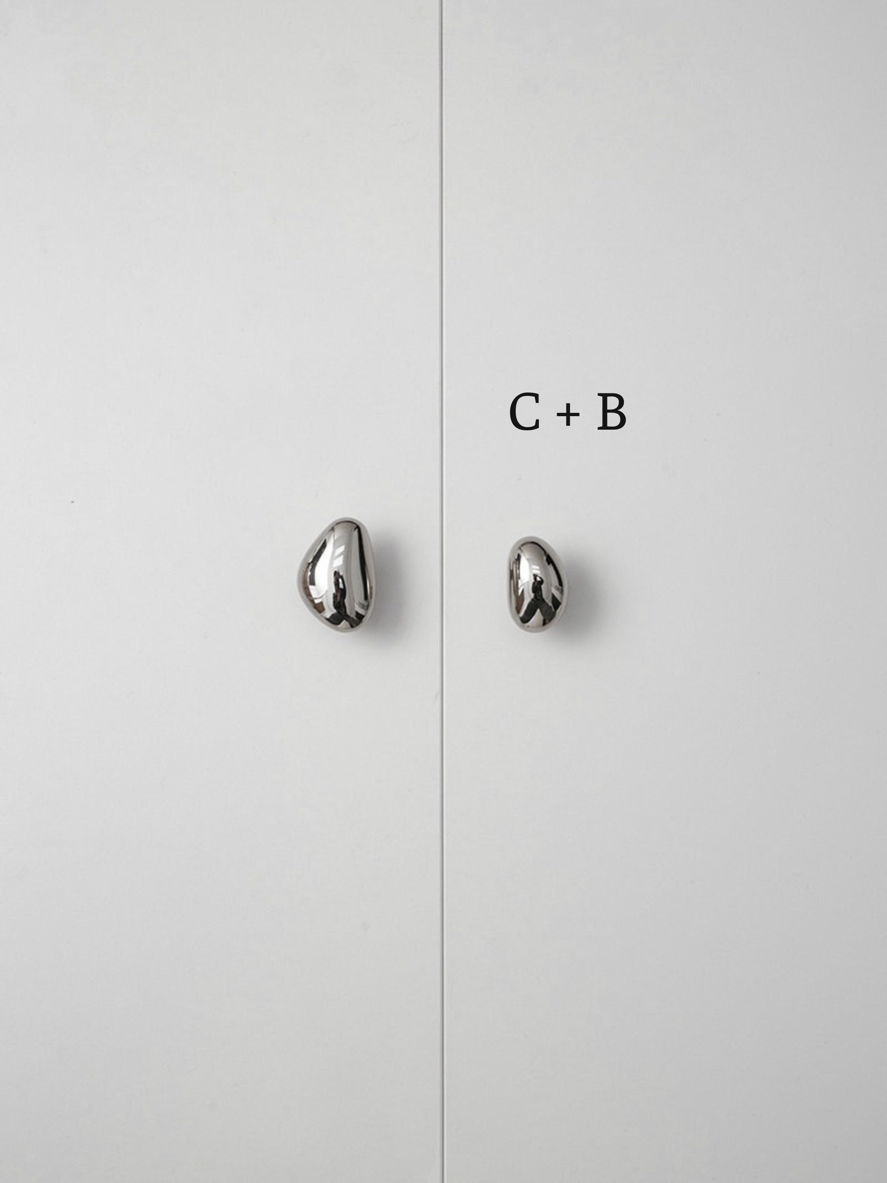 Polished chrome pebble knobs on white cabinet doors labeled size C plus B comparison