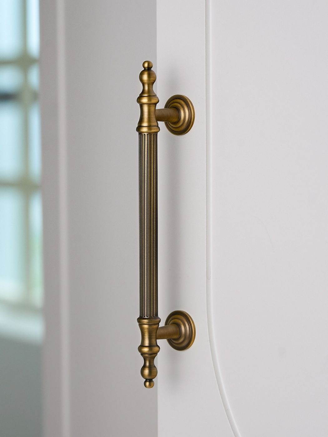Vintage Brass Fluted Pull on White Door Side View