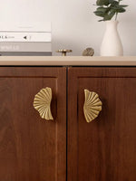 Large ginkgo fan pulls on walnut sideboard cabinet doors