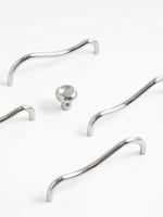 Close-up of chrome wave pull and matching knob