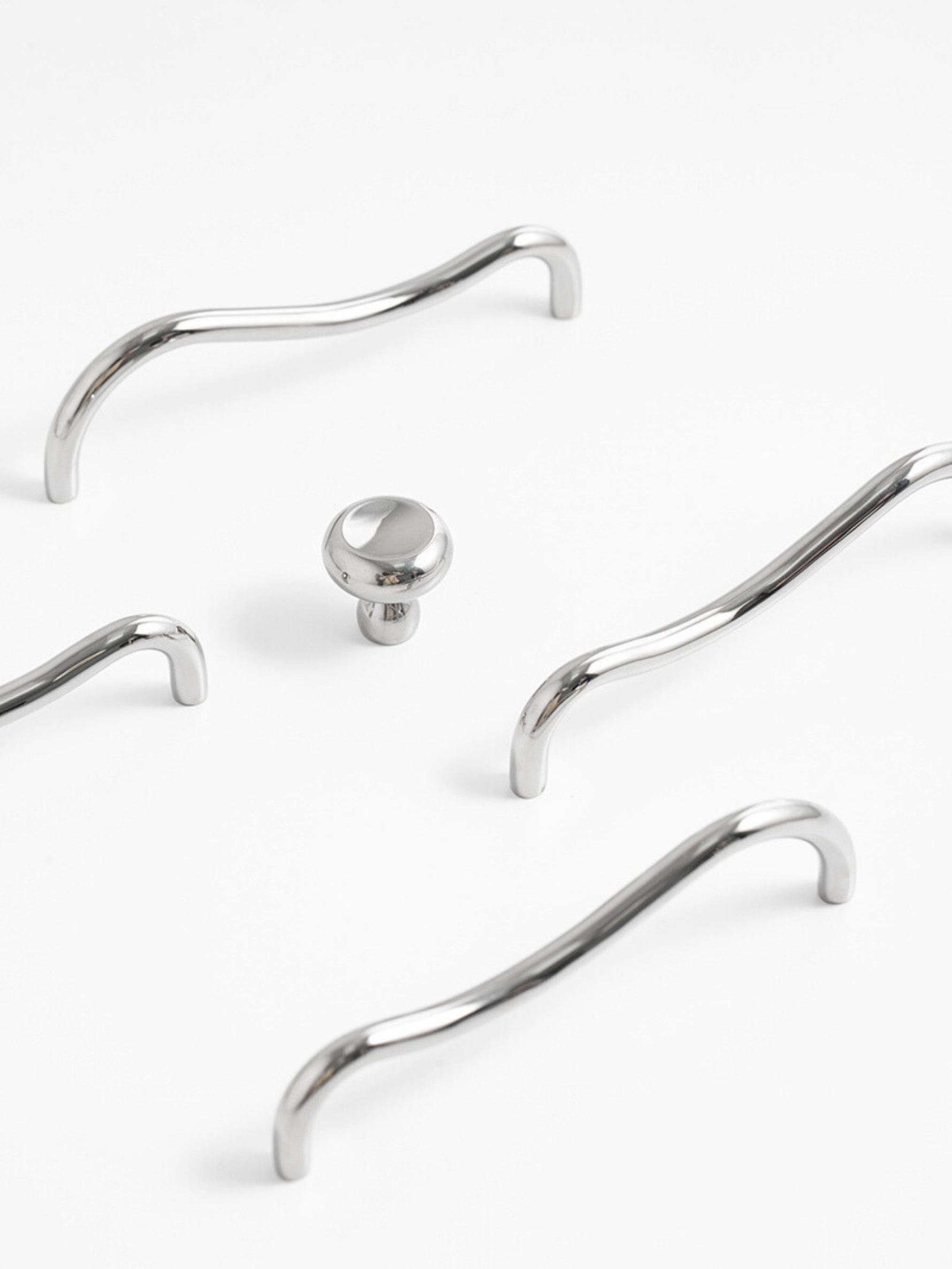 Close-up of chrome wave pull and matching knob