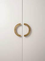 Antique brass sunray arch pulls on white wardrobe doors