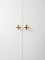 Antique Brass Star Cabinet Knob on White Cabinet Door OlumeHardware