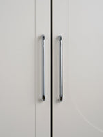Two polished chrome bar pulls on grey cabinet doors, front view