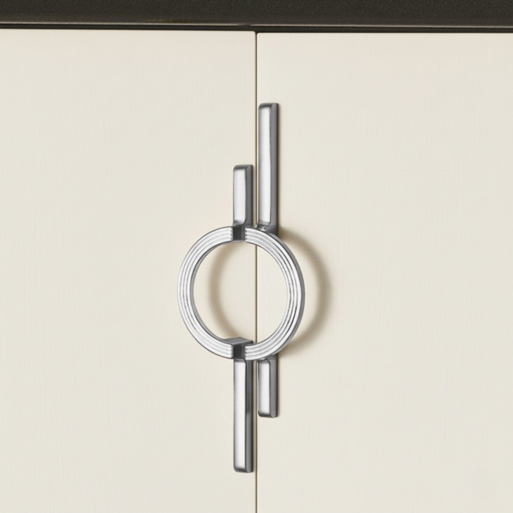 Chrome silver circle ring door pull on cream kitchen cabinet doors