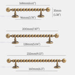Measurement chart of a decorative antique brass pull handle with dimensions labeled.